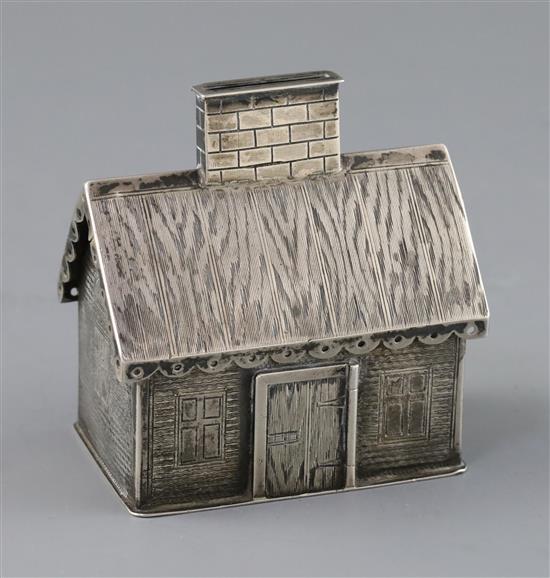 A 19th century Russian silver money box modelled as a dacha, with engraved decoration, coin slot to chimney, KB initials